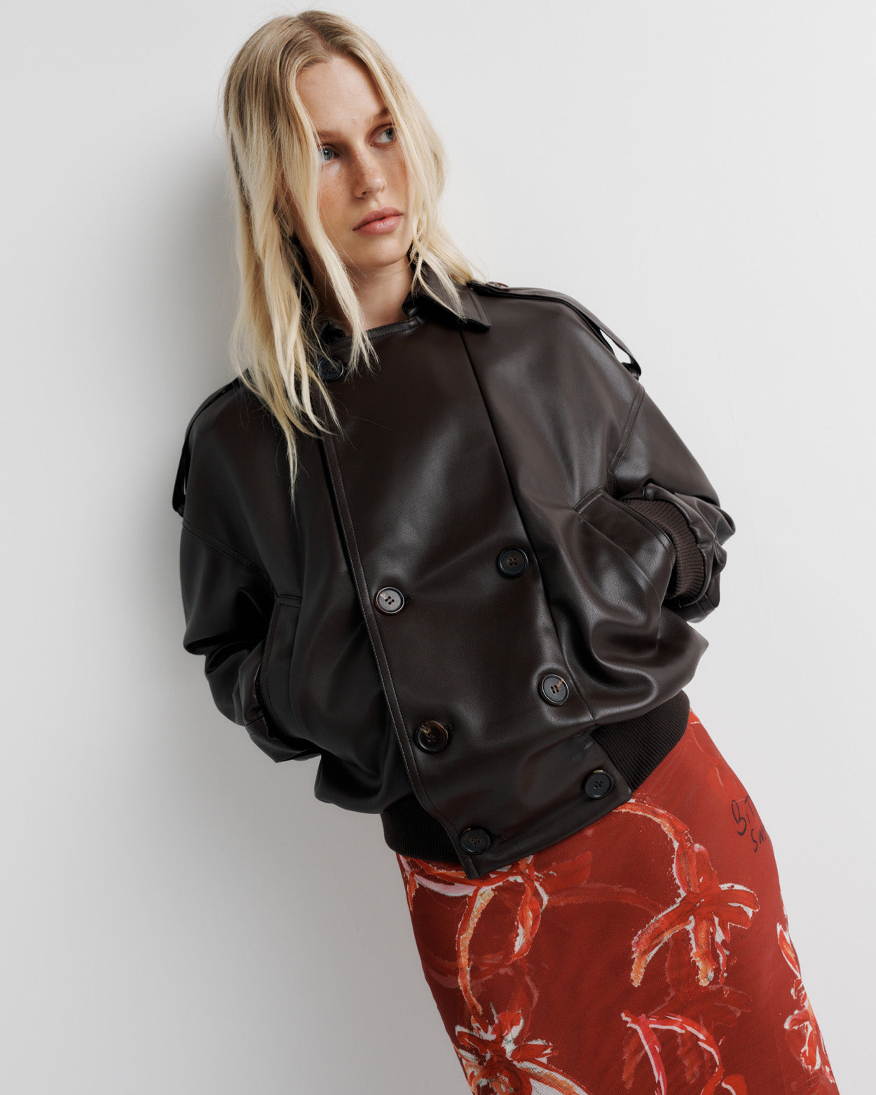 Elevate your wardrobe with the Blair Jacket – a unique bomber-meets-cropped-trench crafted from signature vegan leather. Cinched cuffs and waistband sculpt a flattering silhouette, while the relaxed fit offers effortless drape