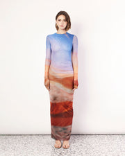 The Sunset Vista Long Sleeve Maxi Dress is a striking dress adorned with the exclusive Romy Sunset Vista print. Featuring double-layered mesh through the body, this dress boasts a breathtaking blend of warm hues that evoke the tranquillity of a setting sun. Crafted with long sleeves for added elegance and versatility, it features a flattering silhouette that gently cascades to the floor. Now available to shop at Romy. 