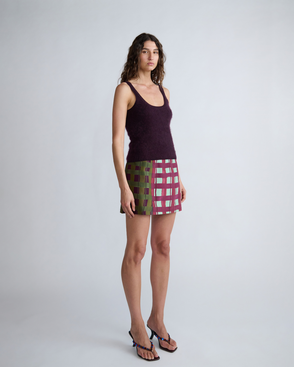 Side view of the Lucy Knit Tank by ROMY highlighting its fitted shape and full-length cut.