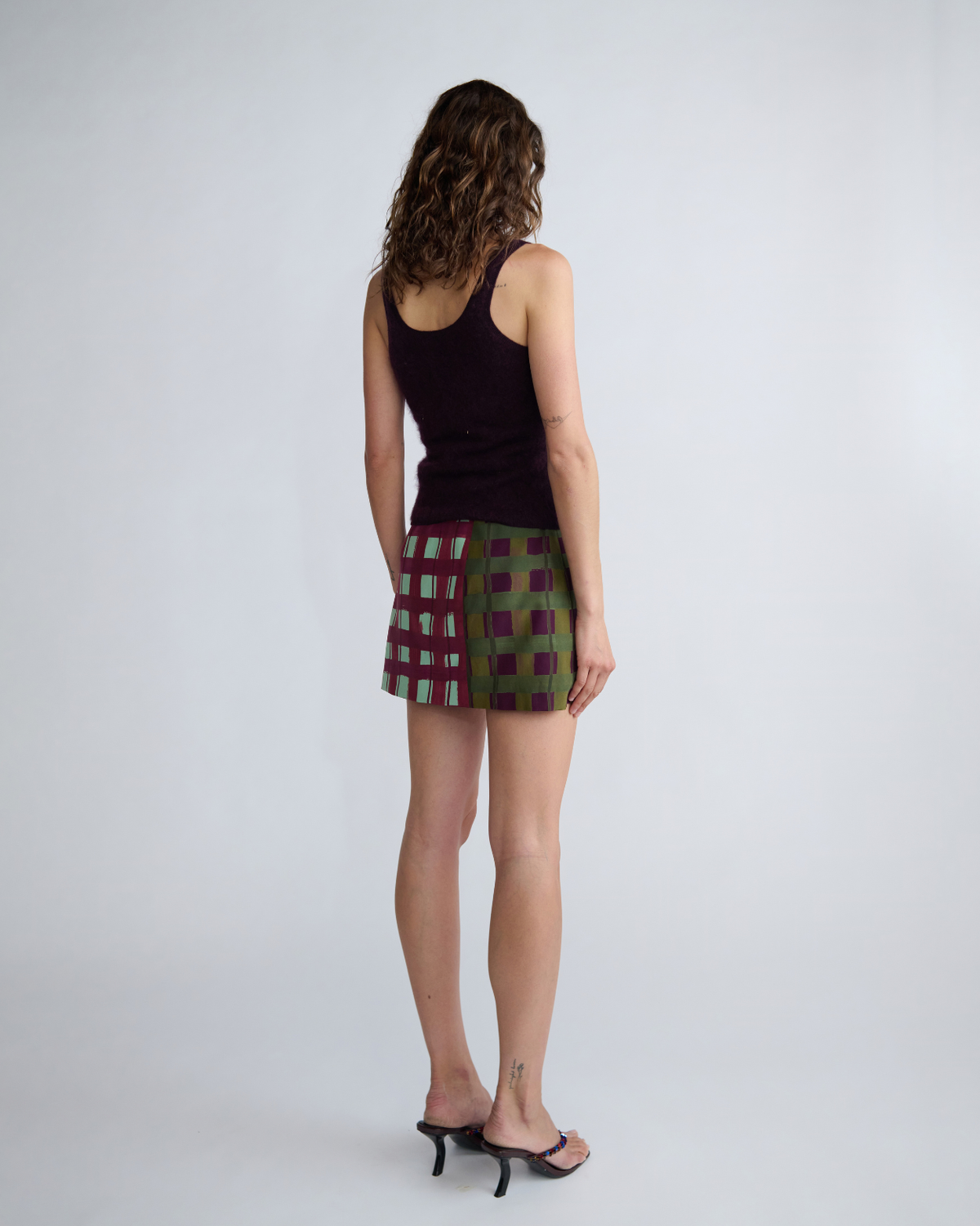 Back view of the ROMY Lucy Knit Tank featuring a deep scoop back neckline and fitted wool knit silhouette.