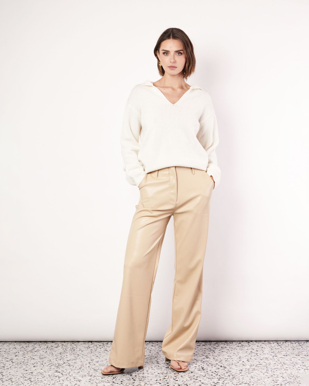 The Vegan Leather Pant are a mid-rise straight leg pant, featuring pockets, belt loops and a hidden clasp closure. They are crafted from a buttery soft Vegan Leather fabrication in Tan. Now available at Romy. 