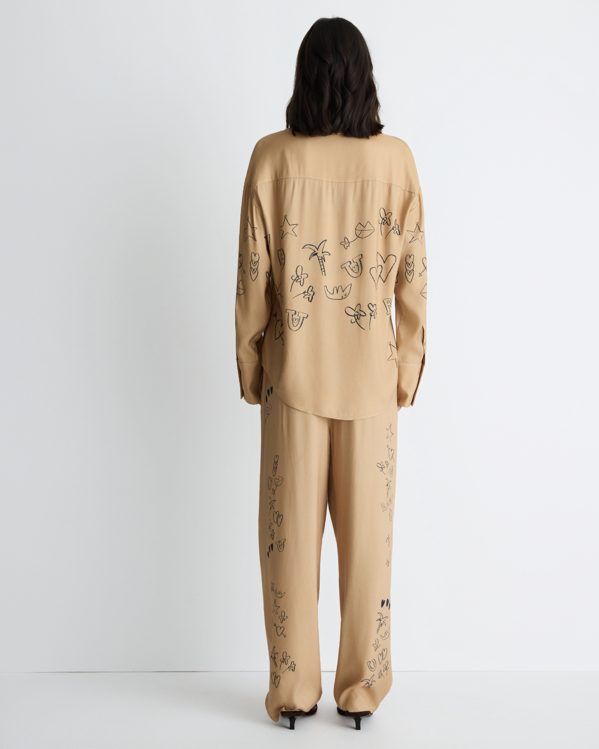 Jakey Shirt in sand with artwork, back view on model.