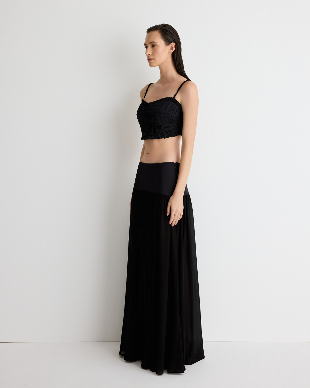 Harper Skirt in sheer black with the Daisy Bustier, three-quarter view on model.