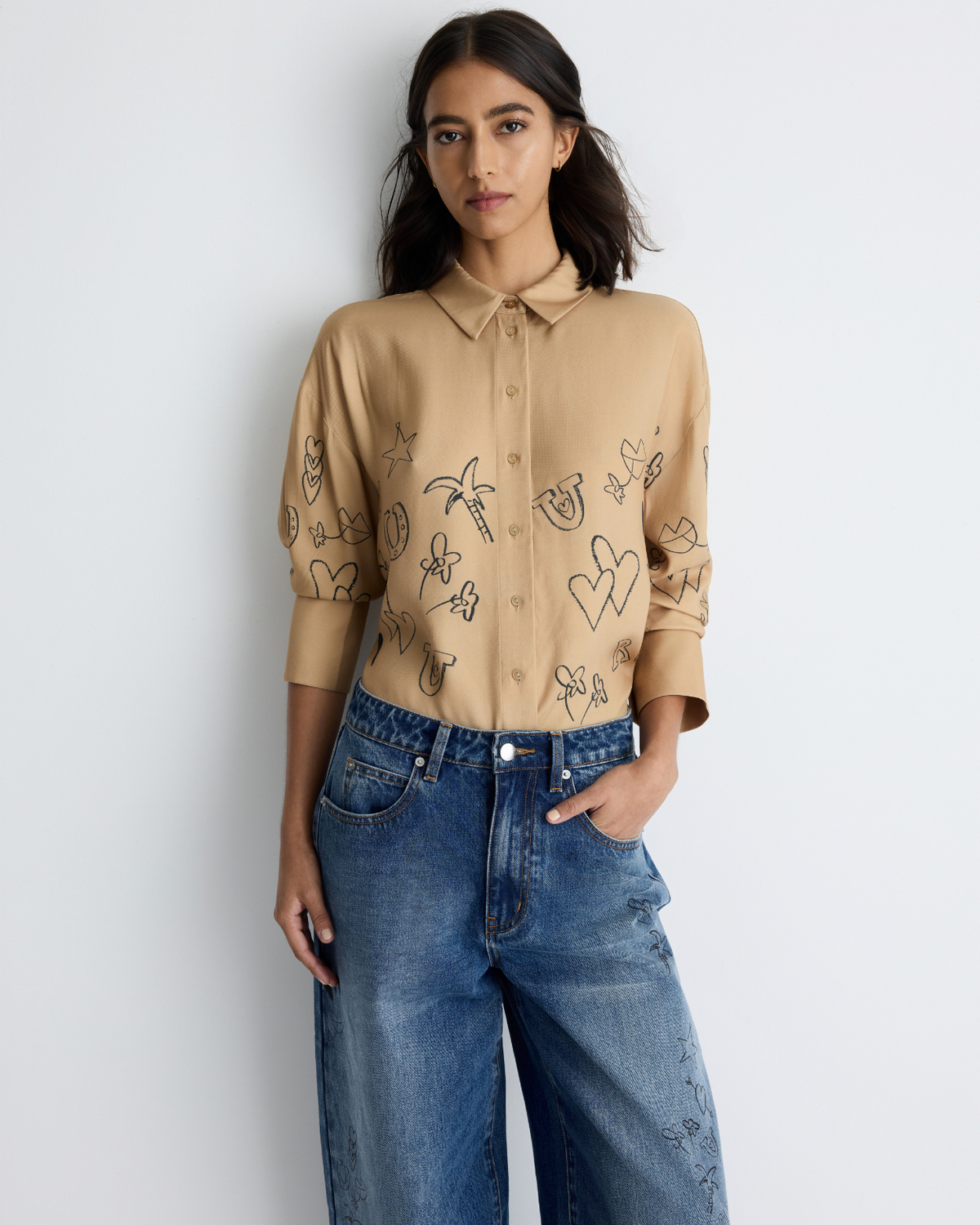 Jakey Shirt in sand with artwork, styled with jeans, front view on model.
