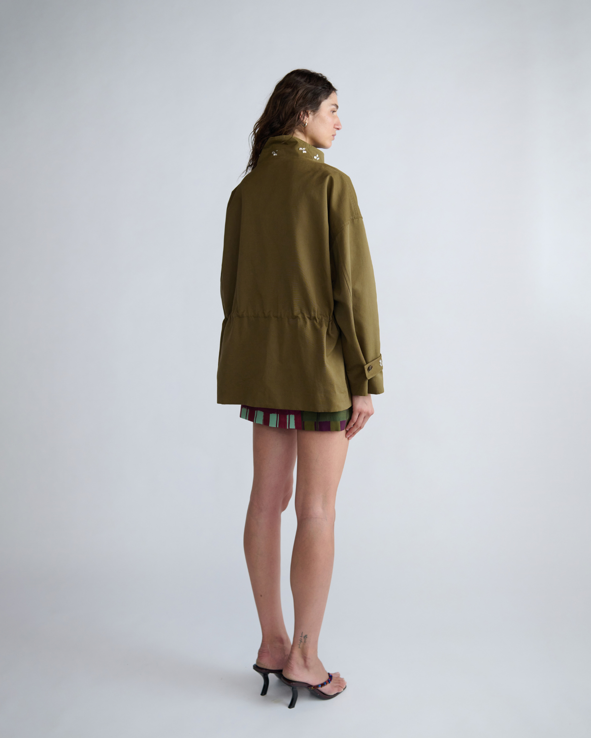 Rear three-quarter view of the ROMY Forever Jacket showing the oversized sleeves and adjustable waist.