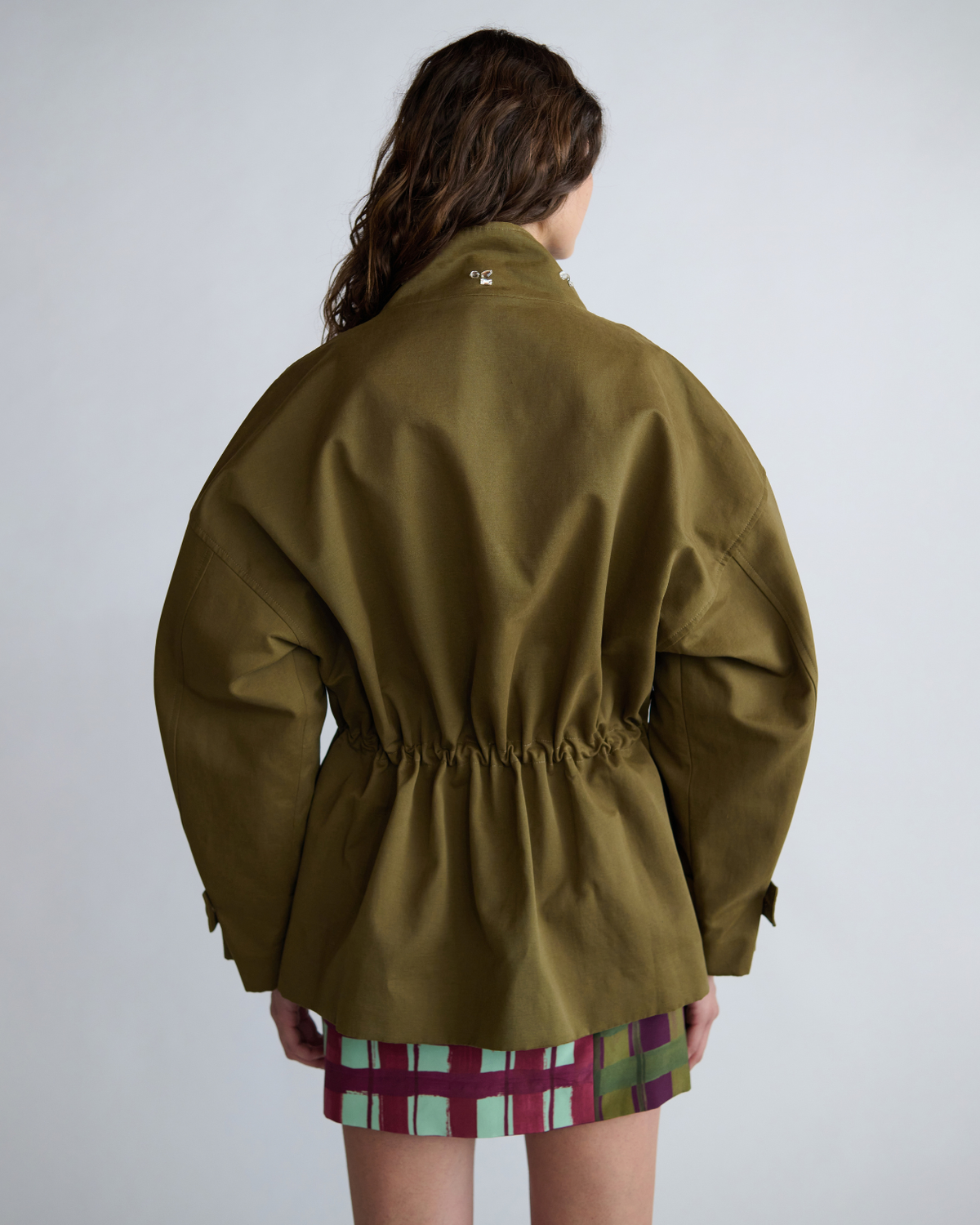 Close-up back view of the khaki Forever Jacket featuring a gathered drawcord waist and dropped shoulders.
