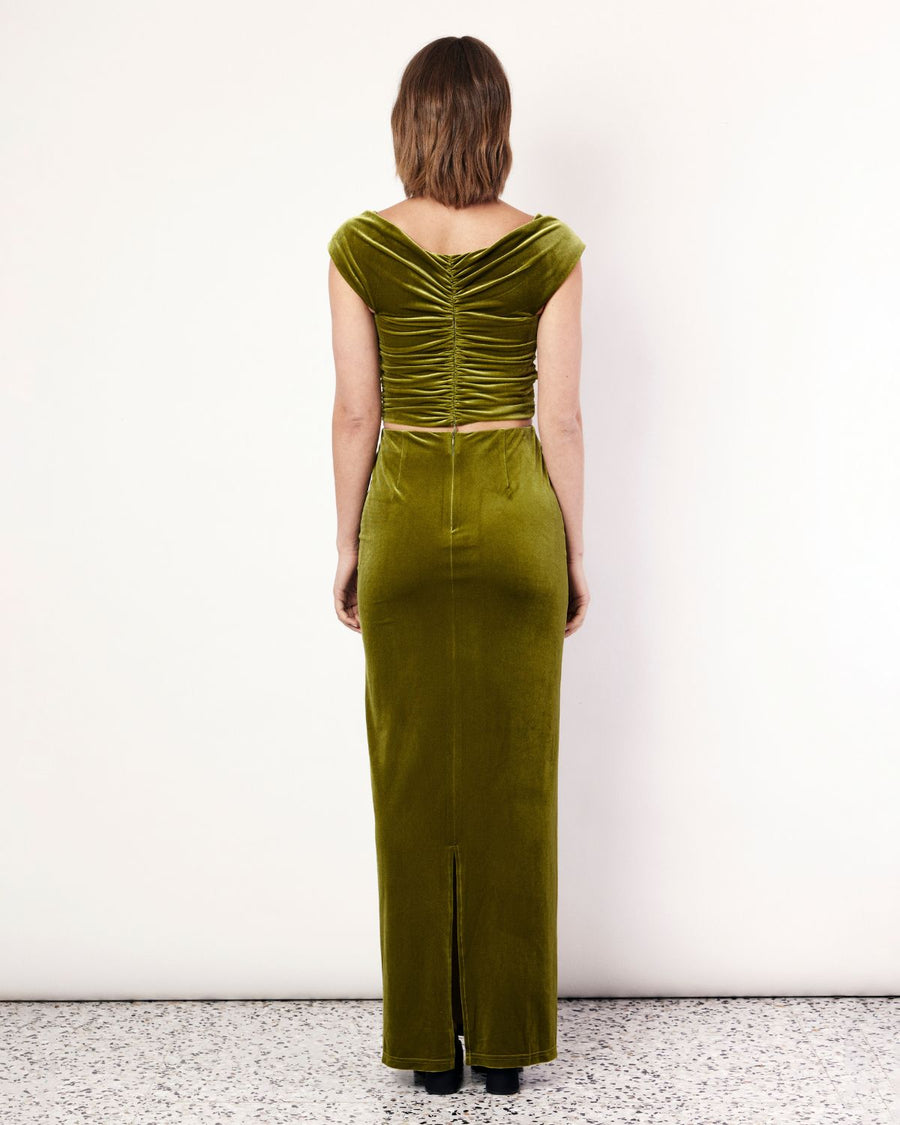 The Velvet Maxi Skirt is a figure hugging silhouette that falls to an elegant maxi length. It has an elastic waistband and is crafted from a plush stretch Velvet fabrication in a stunning green hue. Now available at Romy. 