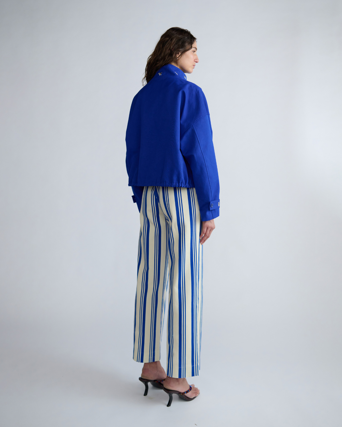 Rear three-quarter view of the ROMY Cropped Forever Jacket showing the cropped length, dropped shoulders and adjustable cuffs.
