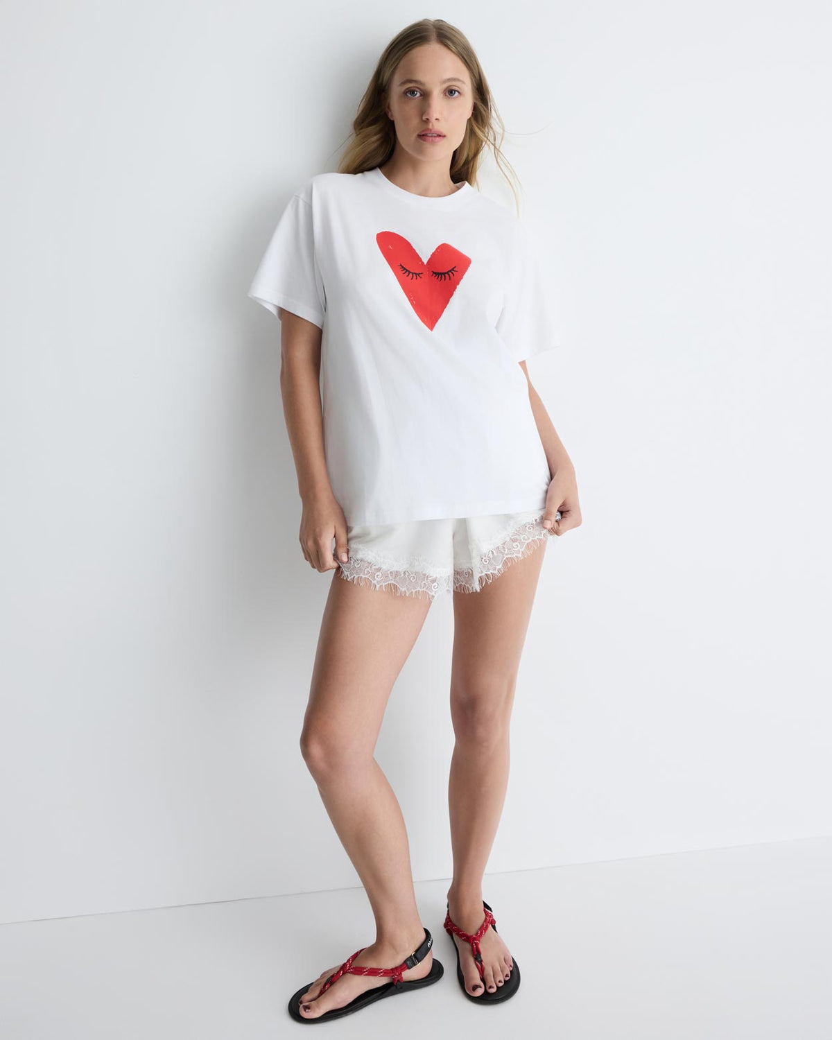 Kiss My Eyes To Sleep Tee in white with red heart, front view on model, alternate.