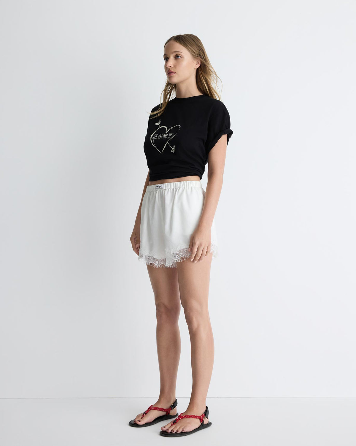 Paris Shorts in white with lace trim, three-quarter view on model.