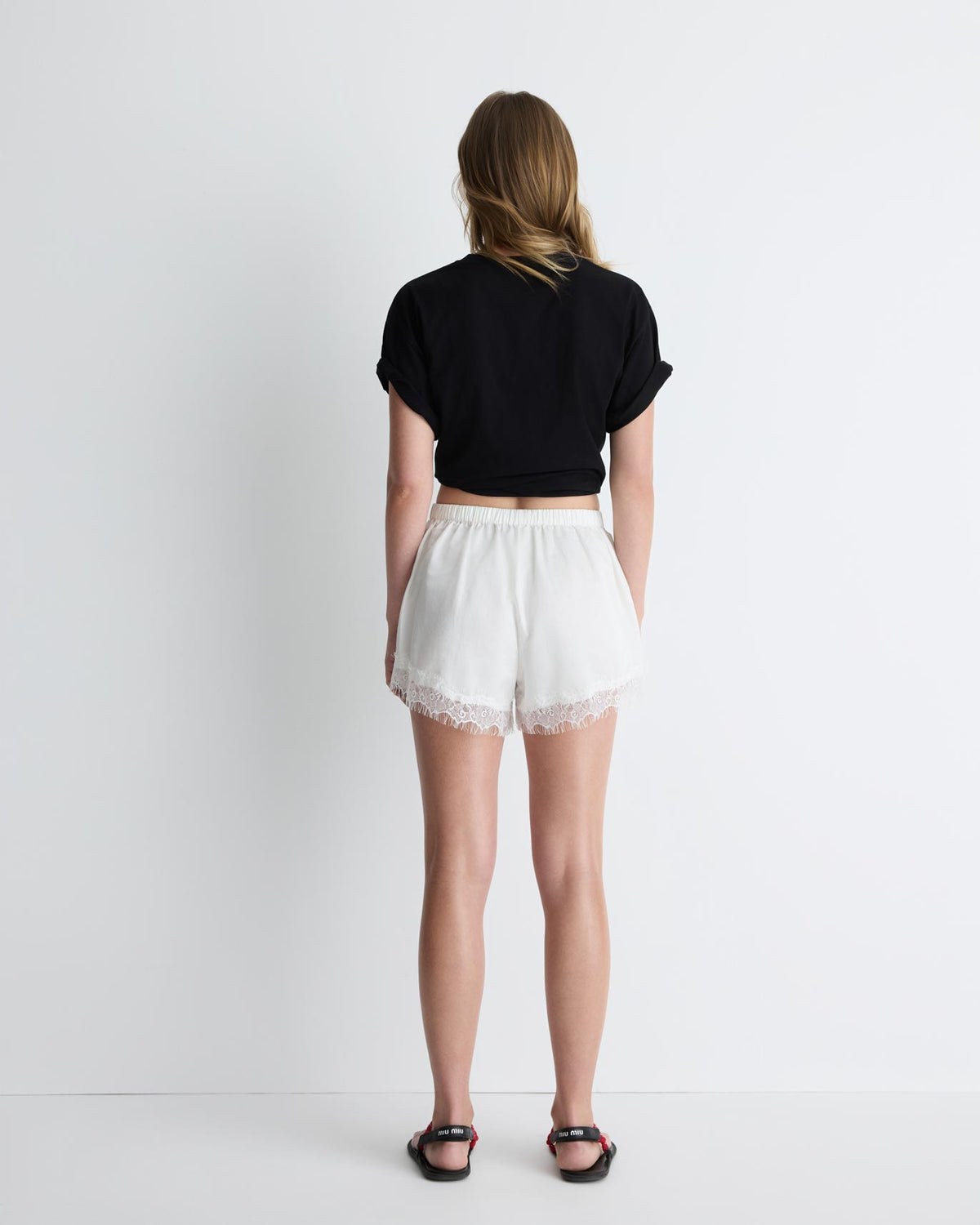 Paris Shorts in white with lace trim, back view on model.