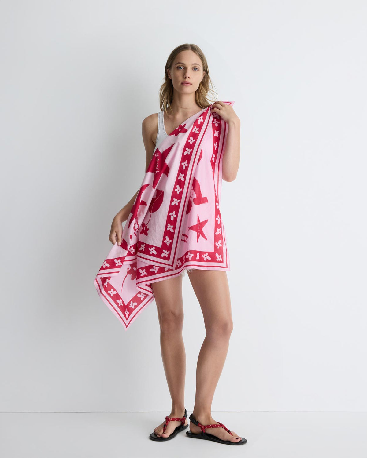 Summer Love Scarf in pink and red print, held open, front view on model.