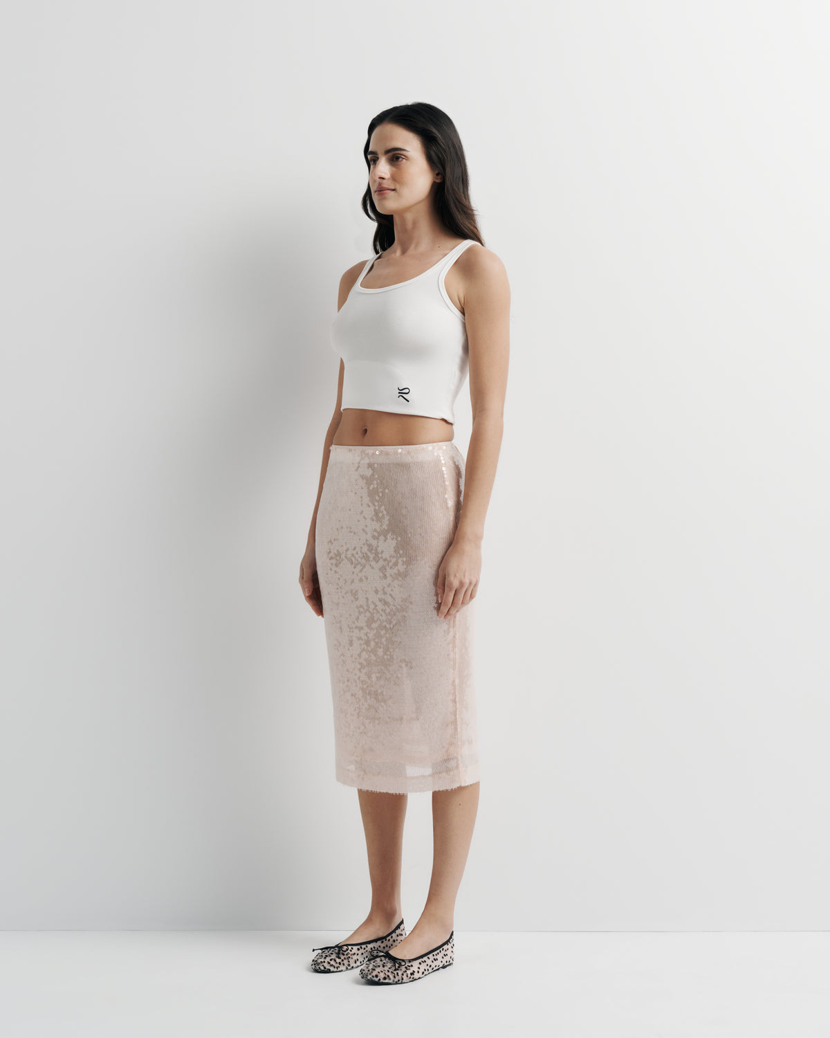 Janey Midi Skirt in pink sequin with polyester mesh lining, front view on model, alternate pose.
