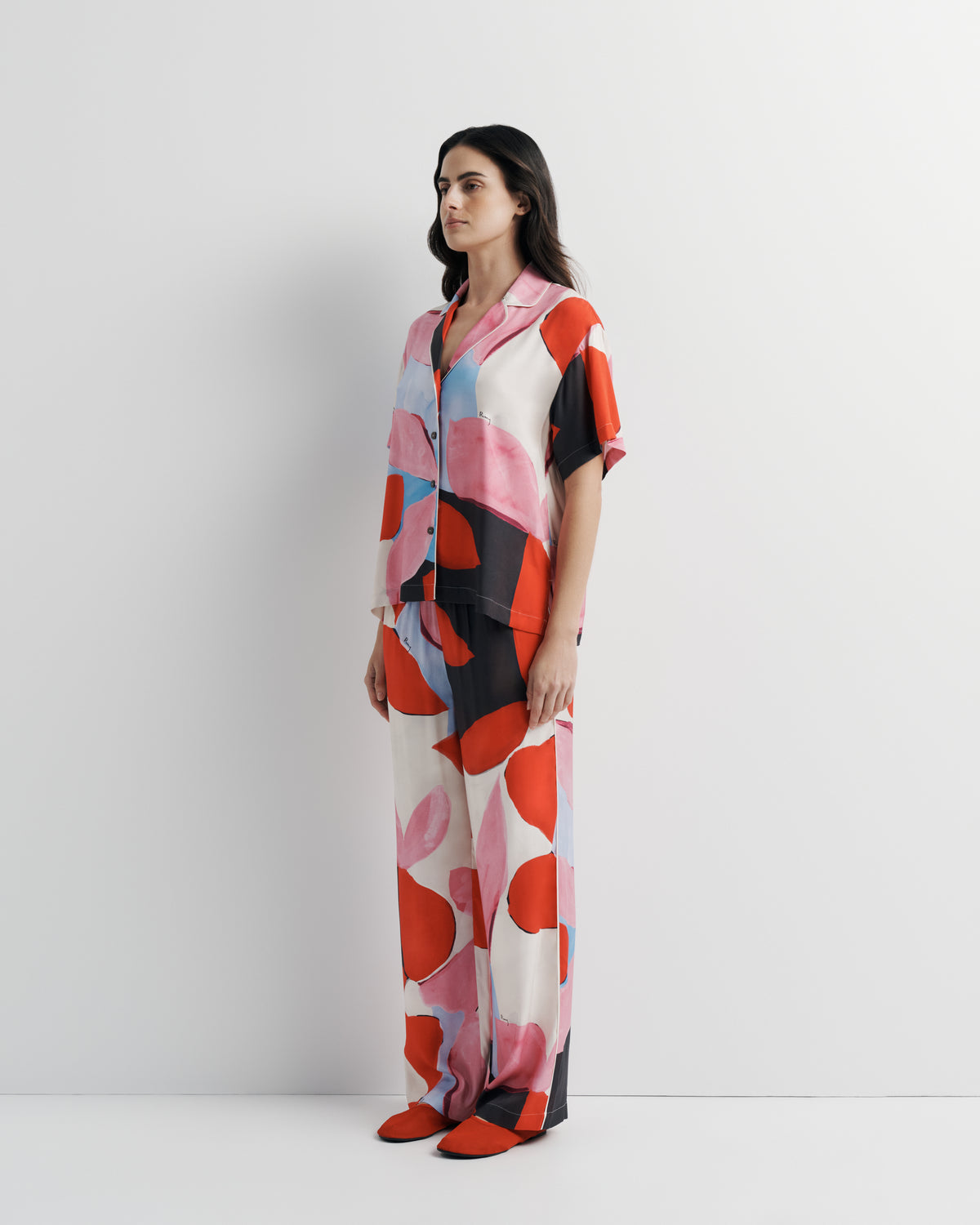 Reese Shirt in pink, red and black abstract print, three-quarter view on model, second look.