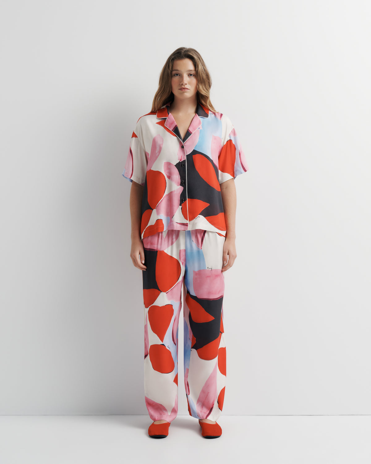 Reese Shirt in pink, red and black abstract print, front view on model.
