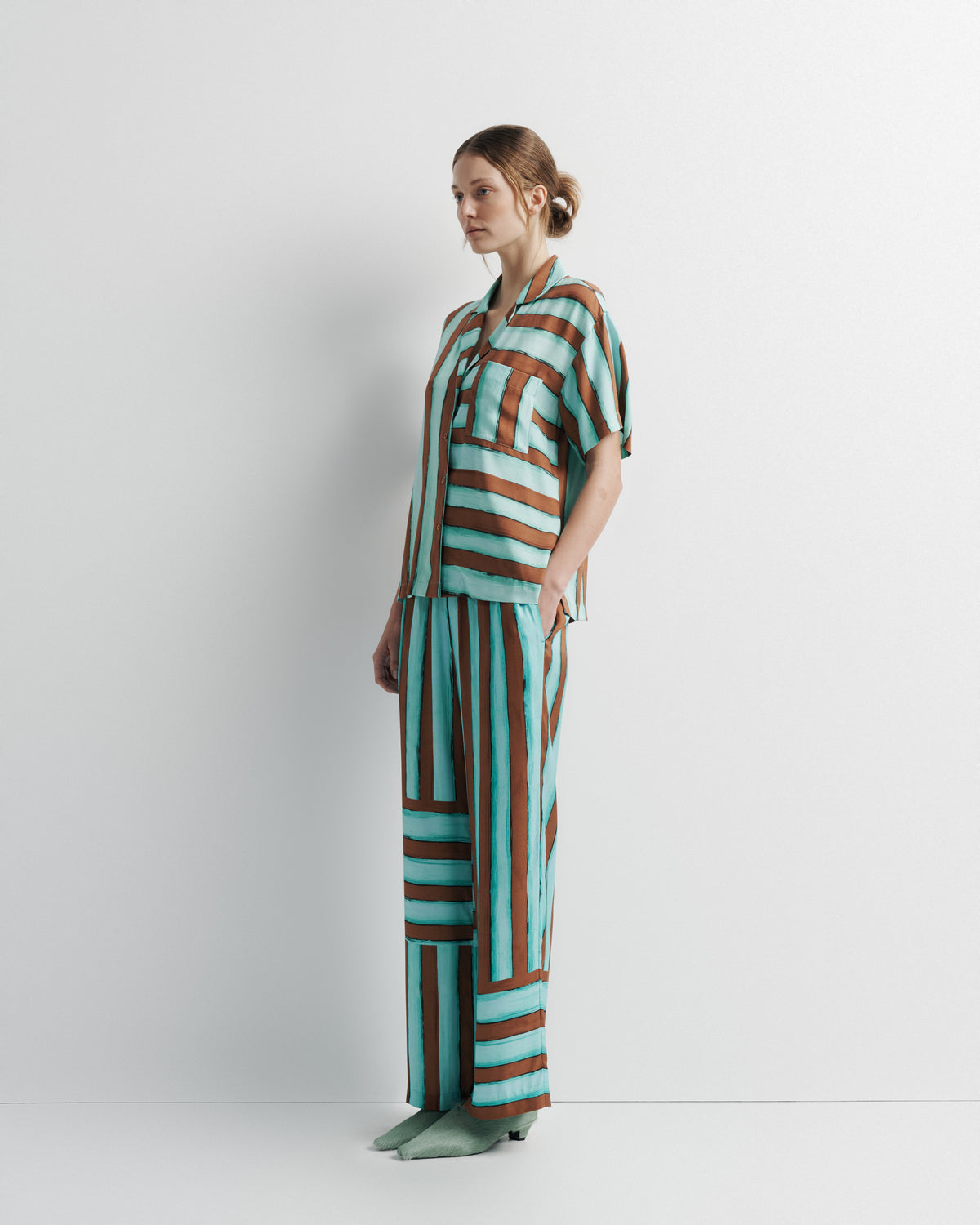 Reese Shirt in aqua and rust hand-painted print, three-quarter view on model.