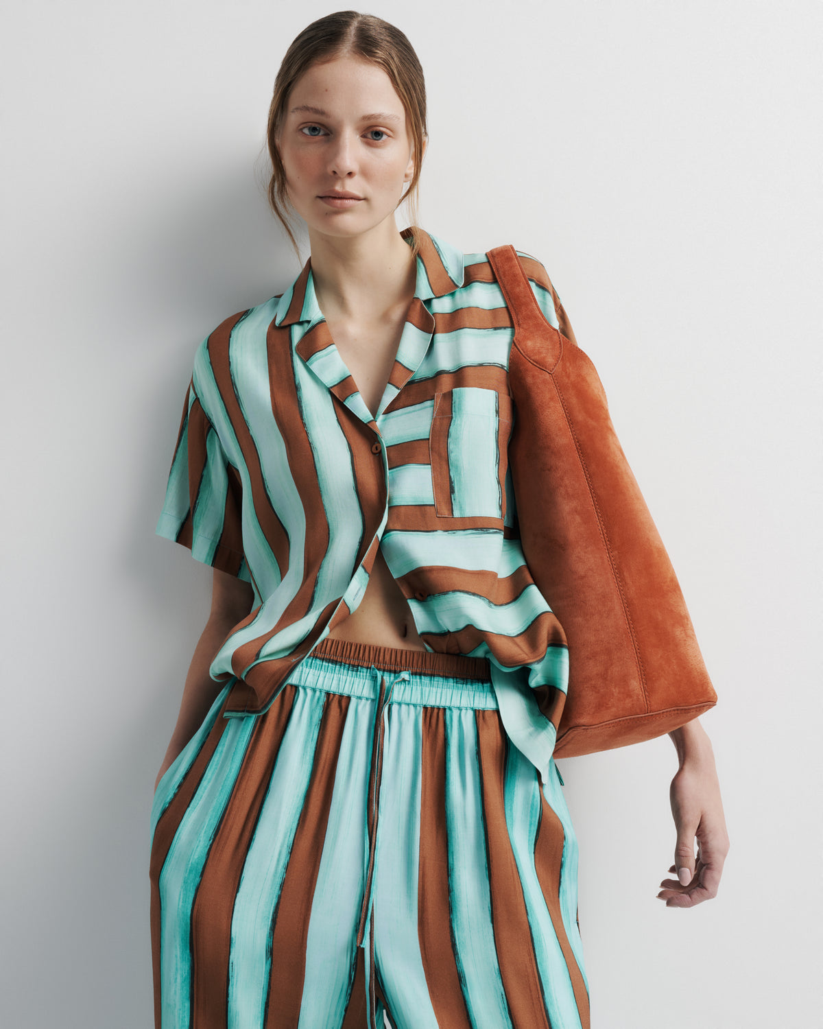 Reese Shirt in aqua and rust hand-painted print, front close-up on model, alternate.