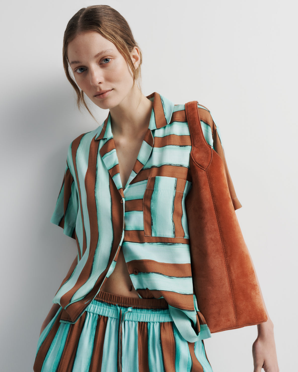 Reese Shirt in aqua and rust hand-painted print, front close-up on model.