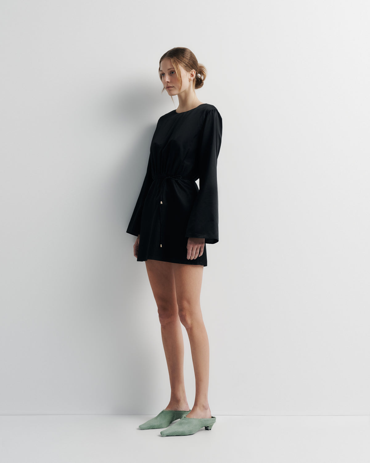 Piper Dress in black, three-quarter view on model.