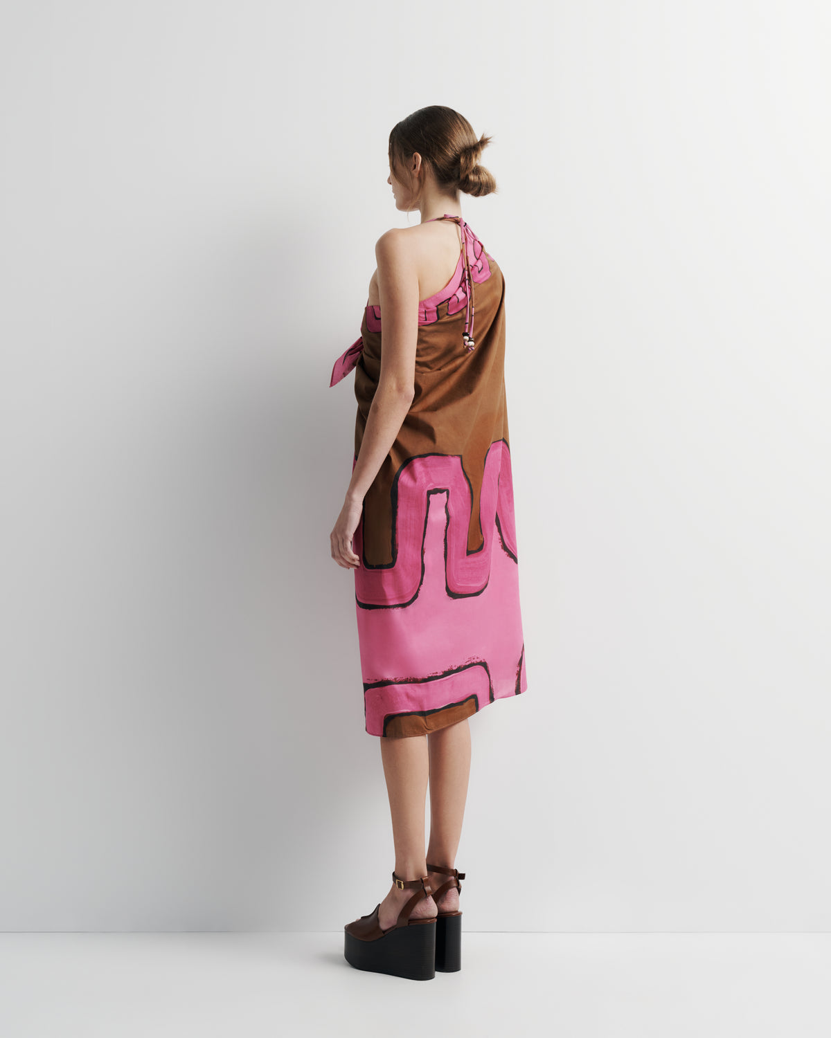 Ritual Sarong in pink and brown print, side view on model.
