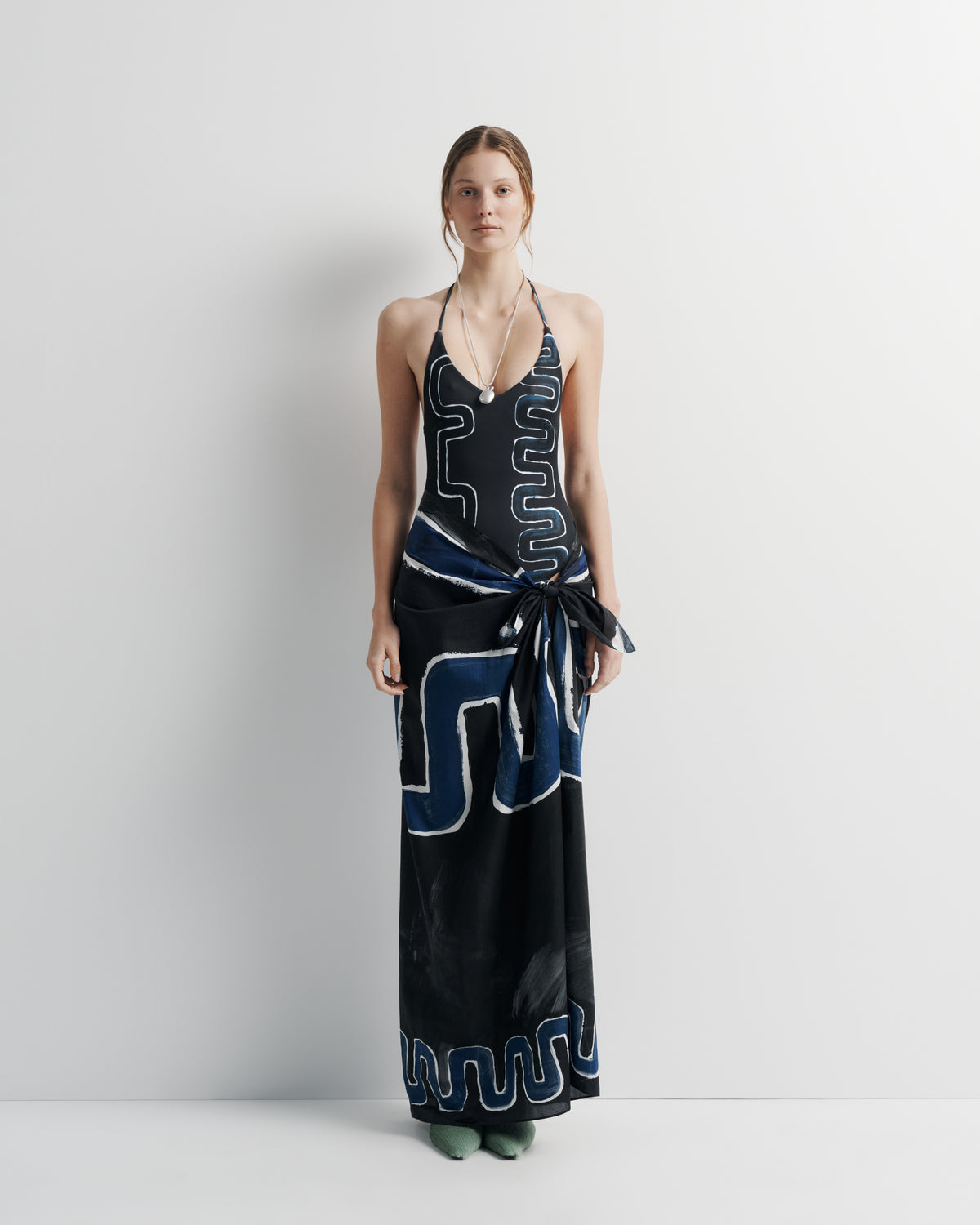 Ritual Sarong in black and blue print, three-quarter view on model.