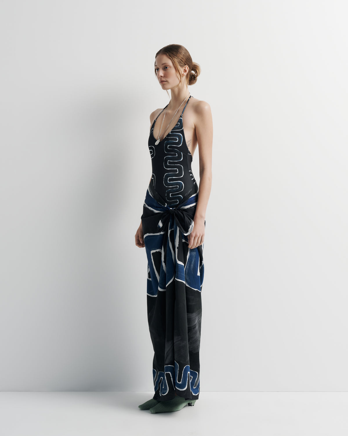 Ritual Sarong in black and blue print, side view on model.