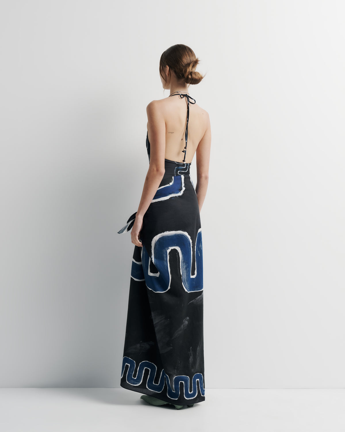 Ritual Sarong in black and blue print, back view on model.