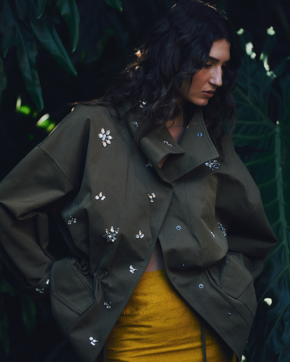 Model wearing the khaki ROMY Forever Jacket with oversized silhouette, funnel neck and crystal embellishments.