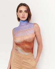 Introducing our exclusive Funneneck Tank in the breathtaking Romy Sunset Vista print. Embrace the beauty of the horizon with this captivating design. Crafted from lightweight mesh, this tank offers both style and breathability, making it perfect for warm days or layered looks. Now available online at Romy. 