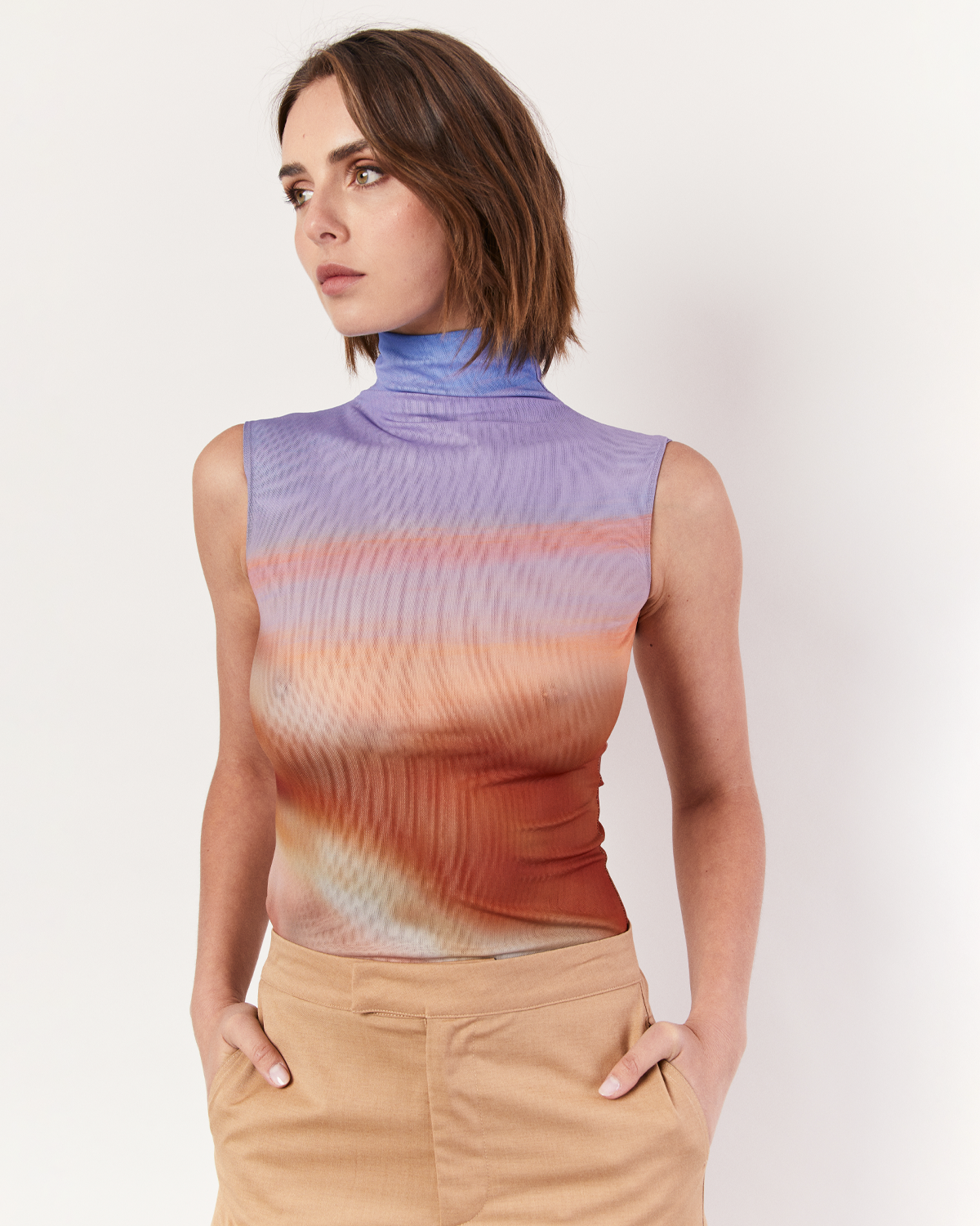 Introducing our exclusive Funneneck Tank in the breathtaking Romy Sunset Vista print. Embrace the beauty of the horizon with this captivating design. Crafted from lightweight mesh, this tank offers both style and breathability, making it perfect for warm days or layered looks. Now available online at Romy. 