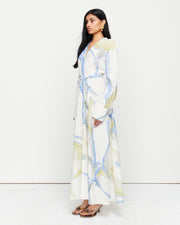 The Anouk Shift Dress is a lightweight shirtdress crafted from a luxurious 70% cotton, 30% silk blend. Designed with a button-through front, pleated waist detailing, and a removable belt for versatile styling. Showcasing an exclusive print created in collaboration with Anouk Colantoni.