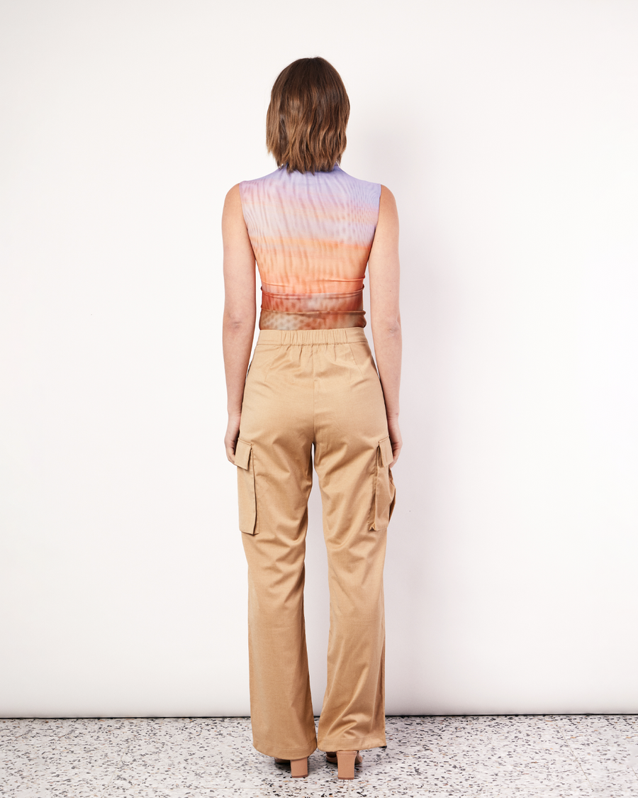 Introducing the return of our popular Cargo Pants now available in a stylish Tan colorway. Crafted from a soft wool blend, these pants boast a relaxed cut with a mid-rise waist for ultimate comfort. They feature side patch pockets, a concealed hook and bar closure, and elasticated hems, combining functionality with effortless style. Now available to shop online at Romy. 