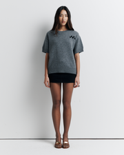 Shop the Cleo Short Sleeve Sweater made from a luxurious 90% wool and 10% cashmere blend. Featuring a relaxed fit, dropped shoulders, crew neck, and ribbed hem detailing, this lightweight, breathable sweater adds comfort and style to your wardrobe. Perfect for layering or wearing on its own.