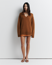 Ingrid Sweater: A relaxed V-neck knit crafted from a soft wool-cashmere blend. Features a slouchy fit with dropped shoulders and chunky ribbing for effortless, everyday comfort. Shop the look now.