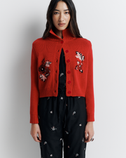 The Lara Cardigan is a fitted, collared knit featuring delicate floral motifs and a timeless button-front design—perfect for layering with a touch of vintage charm.