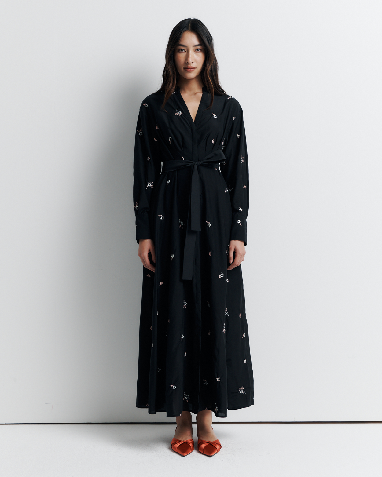 The Lola Shirt Dress is a lightweight, button-through shirtdress featuring pleated waist detailing, a removable belt, and delicate floral embroidery for a romantic, feminine finish.
