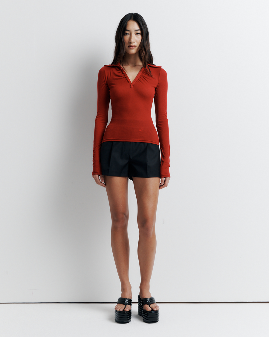 The Louise Knit Top in Red is a collared Henley-style knit featuring soft bust gathers, elongated sleeves for layering, and signature ‘R’ embroidery—an effortlessly polished wardrobe essential.