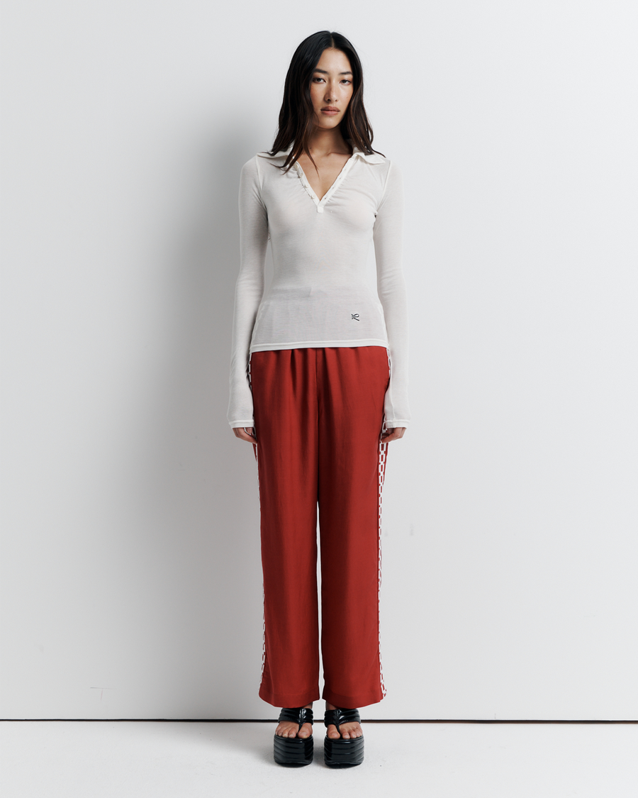 The Louise Knit Top in White is a collared Henley-style knit featuring soft bust gathers, elongated sleeves for layering, and signature ‘R’ embroidery—an effortlessly polished wardrobe essential.