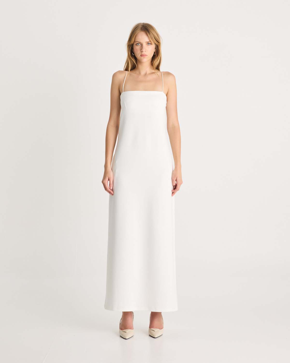 This floor-length bandeau dress is designed in our signature Romy scuba fabric. It features side pockets, delicate rouleau shoulder straps and an inner shelf bra provide both support and an elevated look. This white maxi dress is destined to become your essential wardrobe piece. Available exclusively at Romy and The Iconic. Show now.