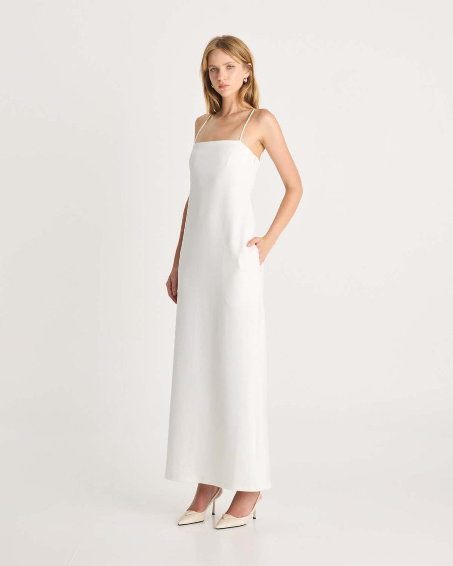 This floor-length bandeau dress is designed in our signature Romy scuba fabric. It features side pockets, delicate rouleau shoulder straps and an inner shelf bra provide both support and an elevated look. This white maxi dress is destined to become your essential wardrobe piece. Available exclusively at Romy and The Iconic. Show now.