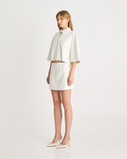 The Vegan Leather Mini Skirt is an elevated silhouette, designed to sit low-mid rise on the hips. Tailored from vegan leather in a bright white, offering a structured, straight fit. Shop online at Romy now with Afterpay and free express shipping available.