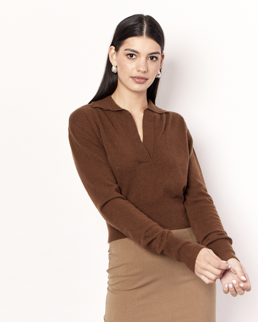 The Cropped Collared Sweater is a trans-seasonal knitwear essential, featuring a collar, deep-v neckline, and cropped hem. It is crafted from a luxurious Wool Cashmere blend in an Olive Brown hue. Now available at Romy. 