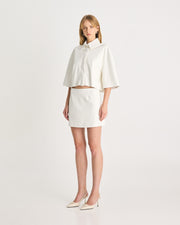 The Vegan Leather Cropped Shirt is back again this season in bright white. Meticulously tailored from supple vegan leather, offering a luxurious feel against your skin. It is cut for an oversized silhouette, ensuring both comfort and style. Size down if you prefer a less slouchy look. Shop online at Romy now with Afterpay and free express shipping available.