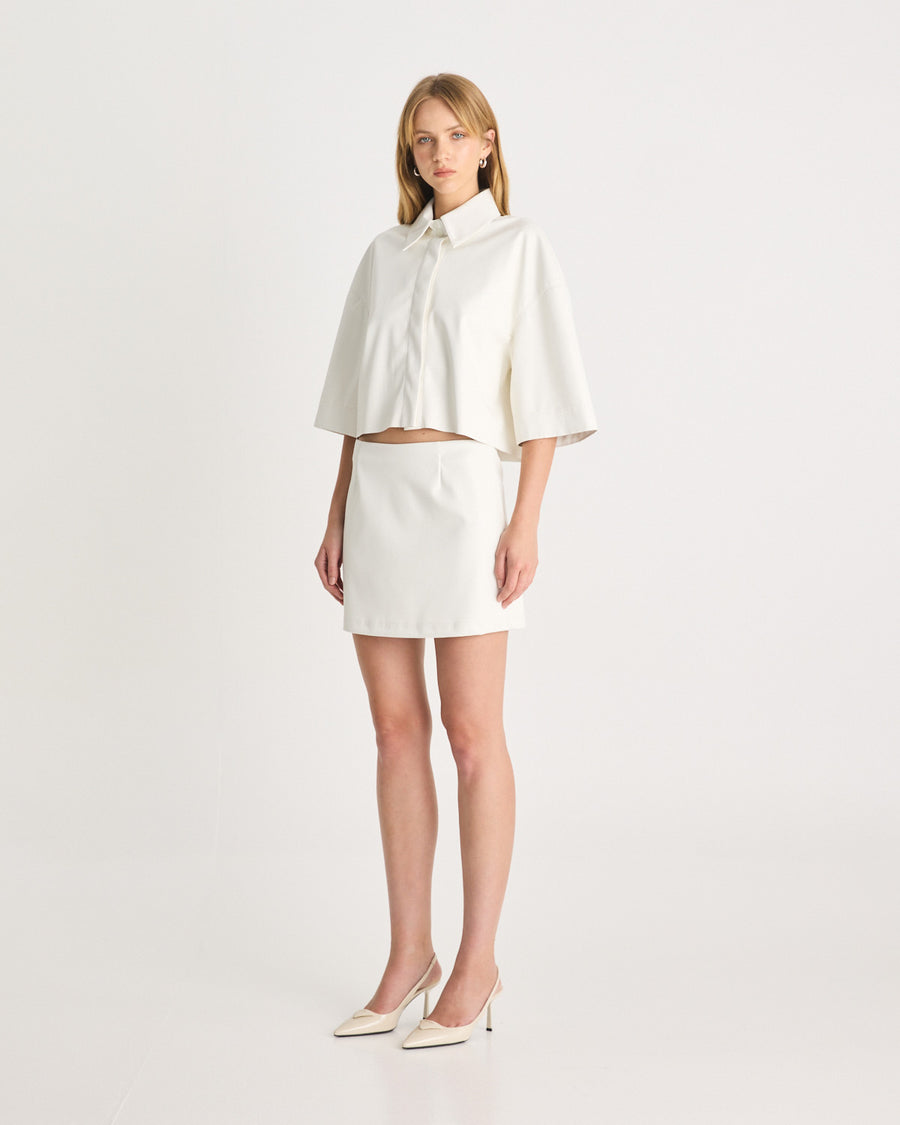 The Vegan Leather Cropped Shirt is back again this season in bright white. Meticulously tailored from supple vegan leather, offering a luxurious feel against your skin. It is cut for an oversized silhouette, ensuring both comfort and style. Size down if you prefer a less slouchy look. Shop online at Romy now with Afterpay and free express shipping available.