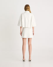 The Vegan Leather Mini Skirt is an elevated silhouette, designed to sit low-mid rise on the hips. Tailored from vegan leather in a bright white, offering a structured, straight fit. Shop online at Romy now with Afterpay and free express shipping available.