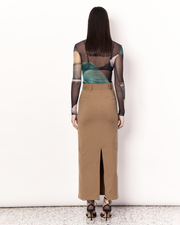 The Maxi Suiting Skirt is a tailored skirt to take you from desk to dinner with ease, featuring belt loops and a back split for ease of wear. It is crafted from a soft wool blend in Tan. Now available at Romy. 