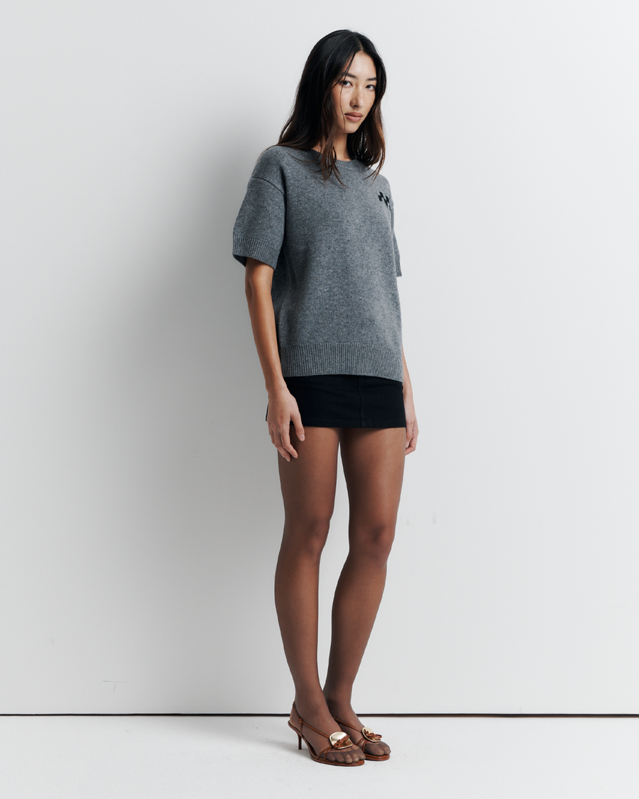 Shop the Cleo Short Sleeve Sweater made from a luxurious 90% wool and 10% cashmere blend. Featuring a relaxed fit, dropped shoulders, crew neck, and ribbed hem detailing, this lightweight, breathable sweater adds comfort and style to your wardrobe. Perfect for layering or wearing on its own.