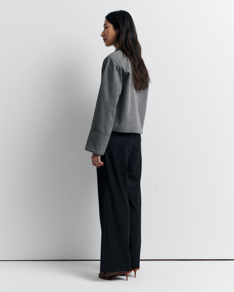 The Gabbi Jacket is a relaxed-fit outerwear piece crafted from soft vegan suede with a contrast pink twill lining. Designed with patch pockets, turn-back cuffs, and a four-button closure for effortless everyday style.