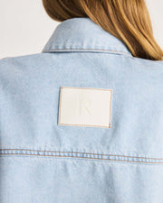 This Denim Shirt is a take on a Romy Classic in a light blue wash in a 100% cotton. It an elevated take on your staple denim shirt that can be styled fastened or open over any dress or tank. Shop now.