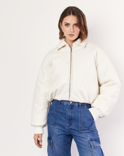 Our best-selling Padded Bomber Jacket is a must-have in your winter wardrobe, featuring a collar, gathered hem, and ribbed knit cuffs. It is crafted from a buttery soft Vegan Leather in Cream. Now available at Romy. 